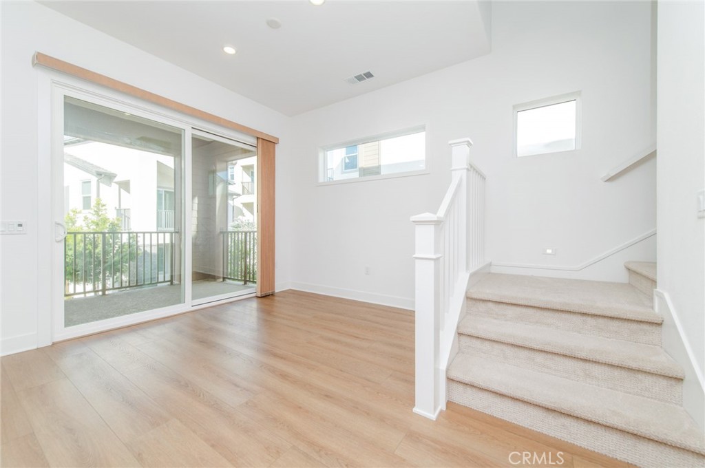 110 Seep Irvine, CA 92618 - Photo 14 of 37 wooden floor in an empty room with a window
