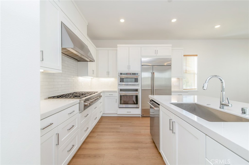 110 Seep Irvine, CA 92618 - Photo 16 of 37 a kitchen with cabinets a sink and stainless steel appliances