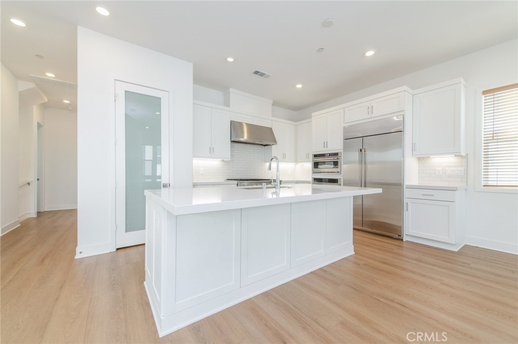 110 Seep Irvine, CA 92618 - Photo 17 of 37 a kitchen with stainless steel appliances kitchen island granite countertop a refrigerator and a sink