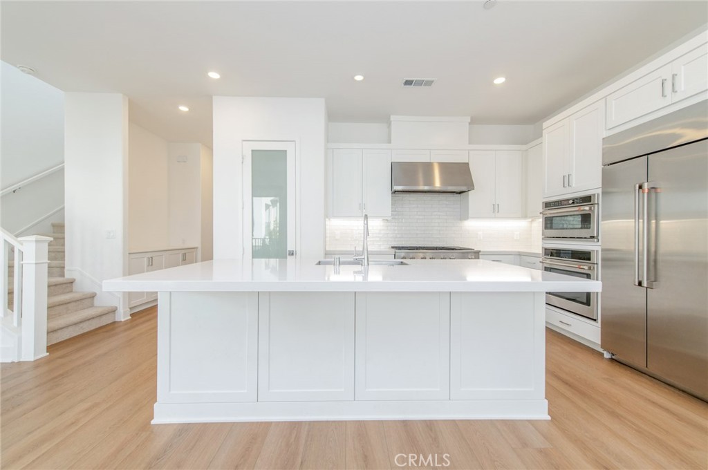 110 Seep Irvine, CA 92618 - Photo 18 of 37 a modern kitchen with stainless steel appliances granite countertop a stove a sink and a refrigerator