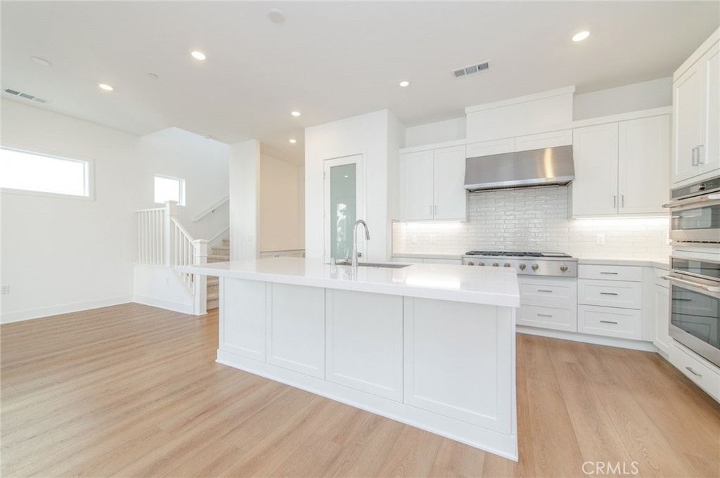 110 Seep Irvine, CA 92618 - Photo 19 of 37 a kitchen with stainless steel appliances granite countertop a stove and a sink