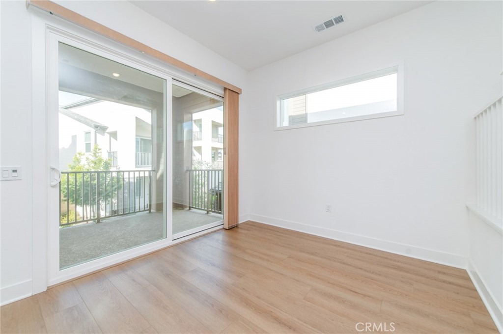 110 Seep Irvine, CA 92618 - Photo 23 of 37 an empty room with wooden floor and windows