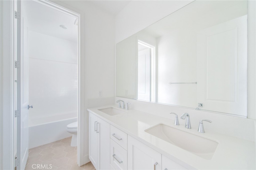 110 Seep Irvine, CA 92618 - Photo 28 of 37 a bathroom with a granite countertop sink toilet and shower