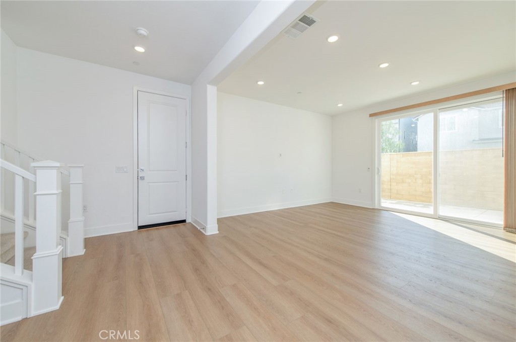 110 Seep Irvine, CA 92618 - Photo 5 of 37 a view of an empty room with wooden floor and a window