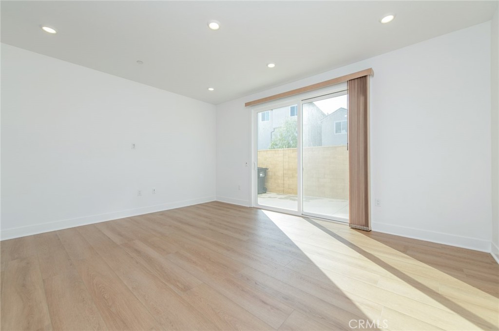110 Seep Irvine, CA 92618 - Photo 6 of 37 a view of an empty room with wooden floor and a window