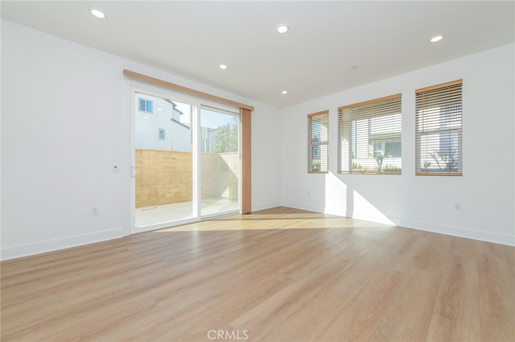110 Seep Irvine, CA 92618 - Photo 7 of 37 an empty room with wooden floor and windows
