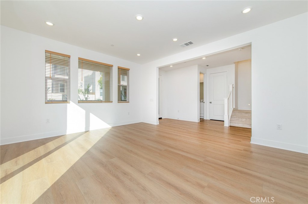 110 Seep Irvine, CA 92618 - Photo 8 of 37 a view of empty room with wooden floor and windows