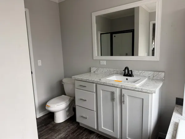 a bathroom with a toilet and a shower