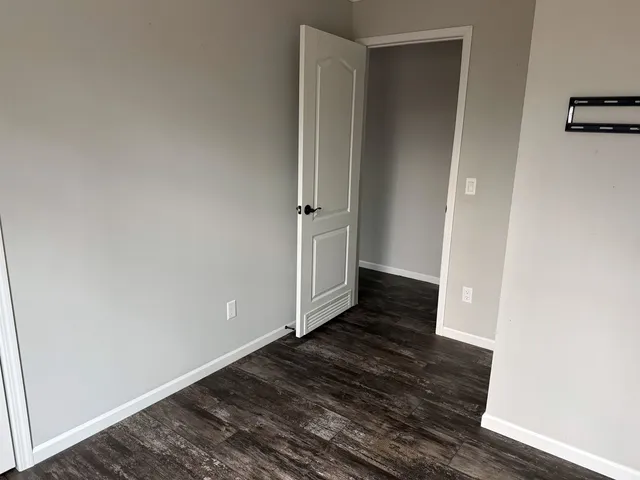 an empty room with wooden floor