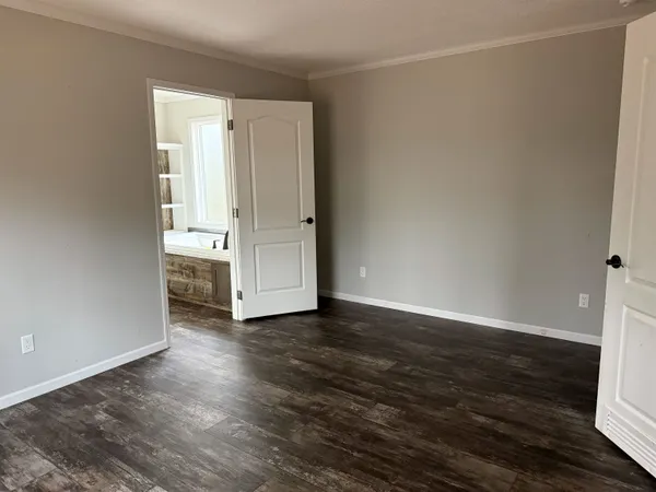 a view of a hallway with a wooden door