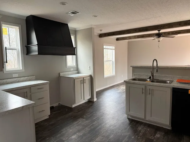 a kitchen with a sink dishwasher a stove and a refrigerator with wooden floor
