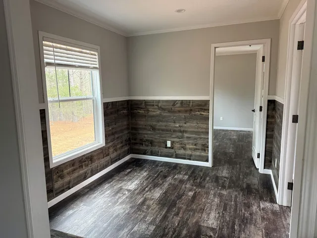 a view of an empty room and a window