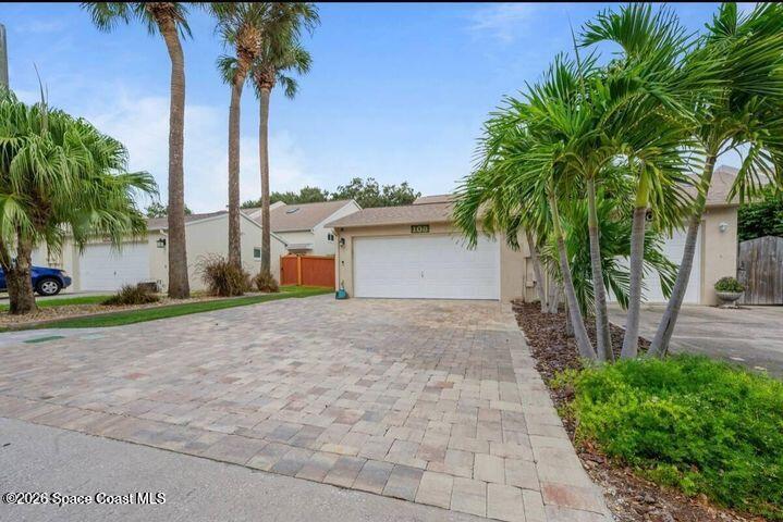 108 Washington Avenue Cape Canaveral, FL 32920 - Photo 1 of 35 a front view of multiple houses with a yard and palm trees