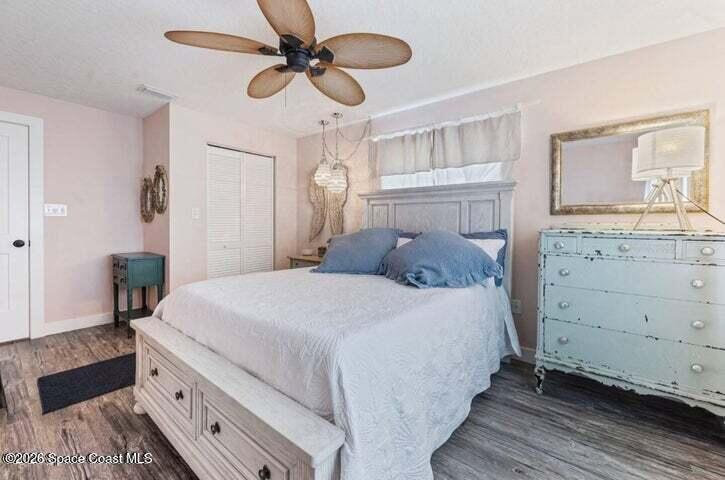 108 Washington Avenue Cape Canaveral, FL 32920 - Photo 20 of 35 a bedroom with a large bed and a chandelier