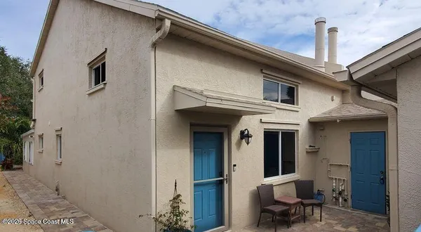 a front view of a house with outdoor seating
