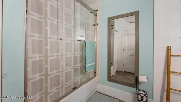 a bathroom with a shower and a toilet