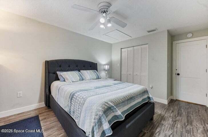 108 Washington Avenue Cape Canaveral, FL 32920 - Photo 24 of 35 a bedroom with a bed and a ceiling fan