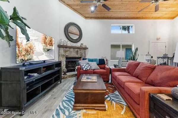 a living room with furniture a fireplace and a flat screen tv