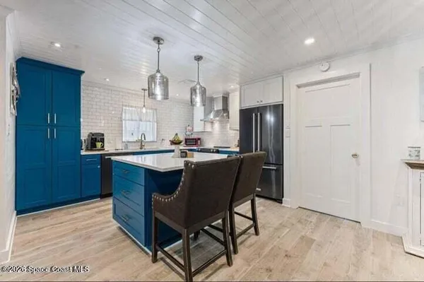 a kitchen with a sink cabinets and appliances