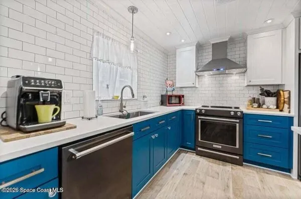 a kitchen with stainless steel appliances a sink stove and cabinets