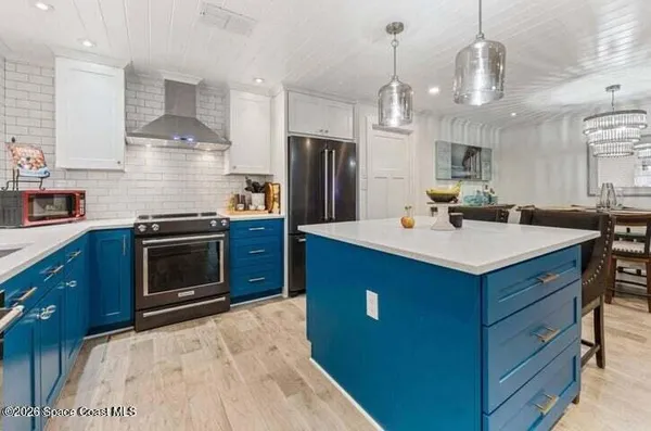 a kitchen with kitchen island a sink stainless steel appliances and cabinets