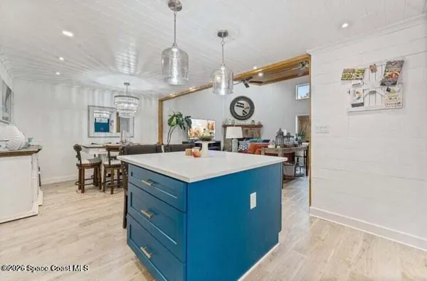 a kitchen with a sink a stove and a clock
