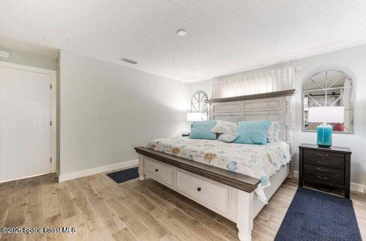 108 Washington Avenue Cape Canaveral, FL 32920 - Photo 10 of 35 a bedroom with a bed and a window