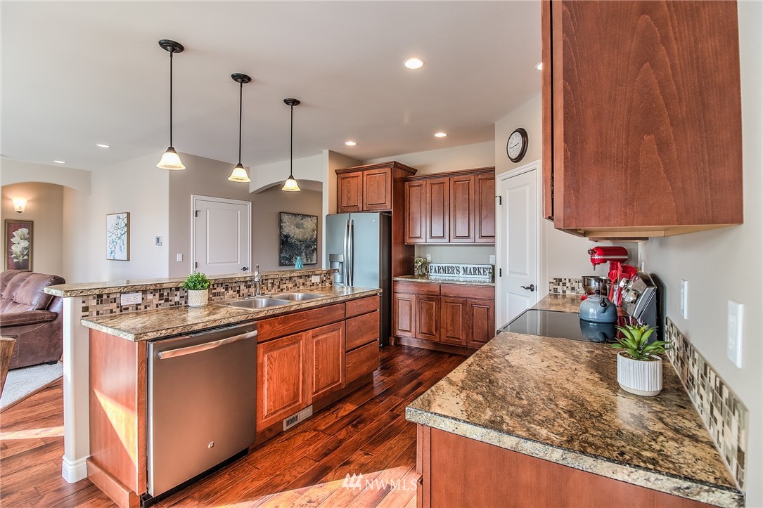 5904 Crestfields Road Yakima, WA 98903 - Photo 11 of 39 a kitchen with kitchen island granite countertop wooden cabinets and a stove