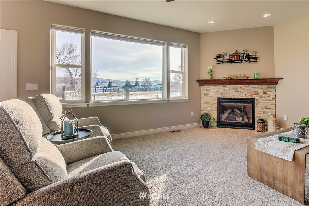 5904 Crestfields Road Yakima, WA 98903 - Photo 19 of 39 a living room with furniture and a fireplace