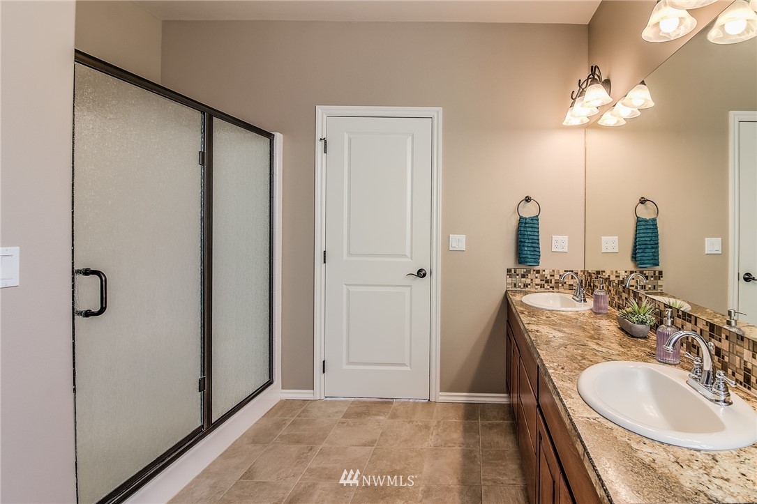 5904 Crestfields Road Yakima, WA 98903 - Photo 24 of 39 a bathroom with a double vanity sink and mirror