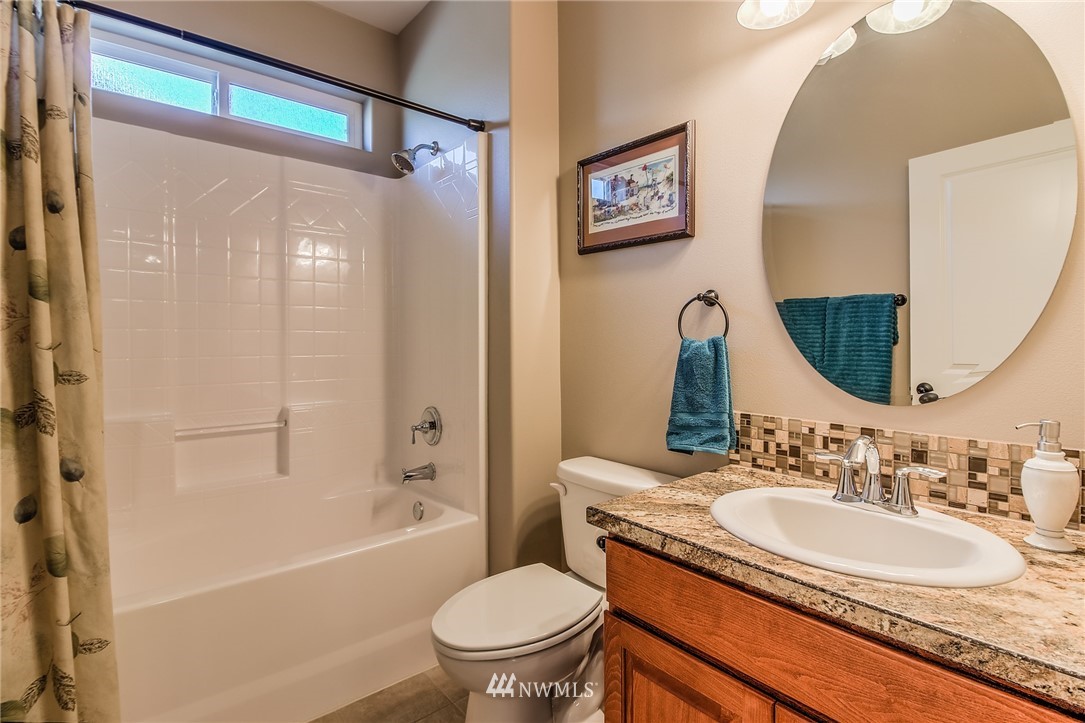 5904 Crestfields Road Yakima, WA 98903 - Photo 31 of 39 a bathroom with a granite countertop sink toilet and shower