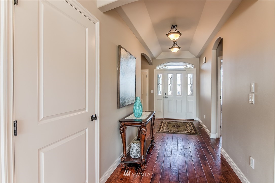5904 Crestfields Road Yakima, WA 98903 - Photo 7 of 39 a view of a hallway with wooden floor and staircase