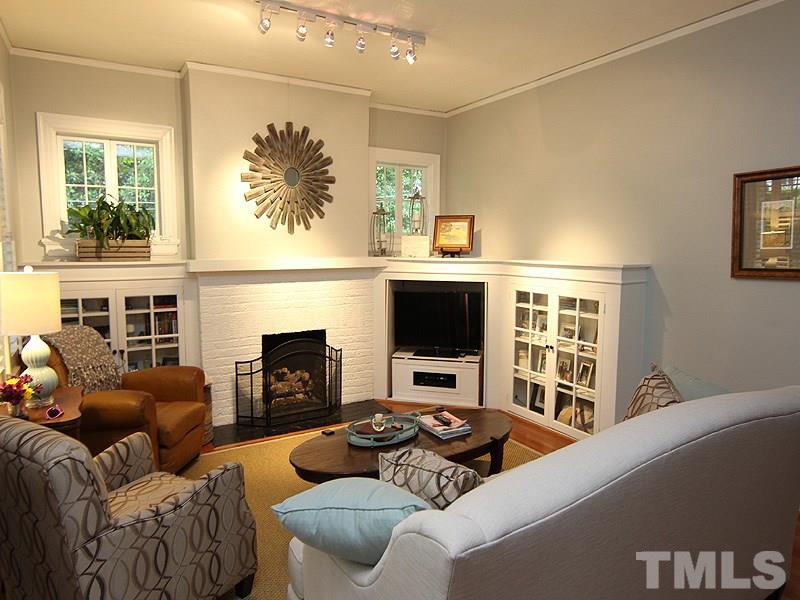 2020 St Marys Street Raleigh, NC 27608 - Photo 7 of 25 a living room with furniture a fireplace and a flat screen tv