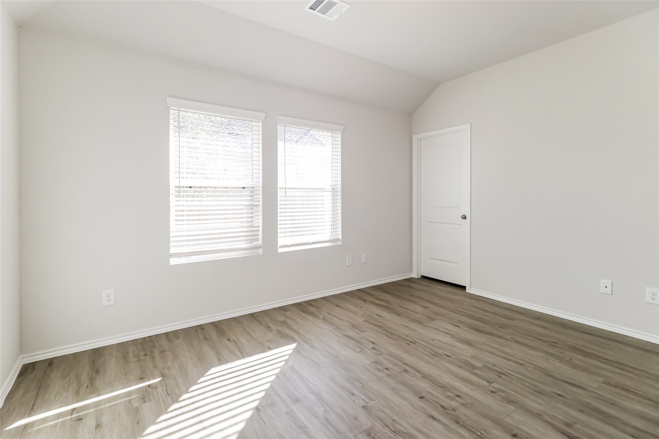 2018 Chunk Court Conroe, TX 77301 - Photo 10 of 16 an empty room with wooden floor and windows