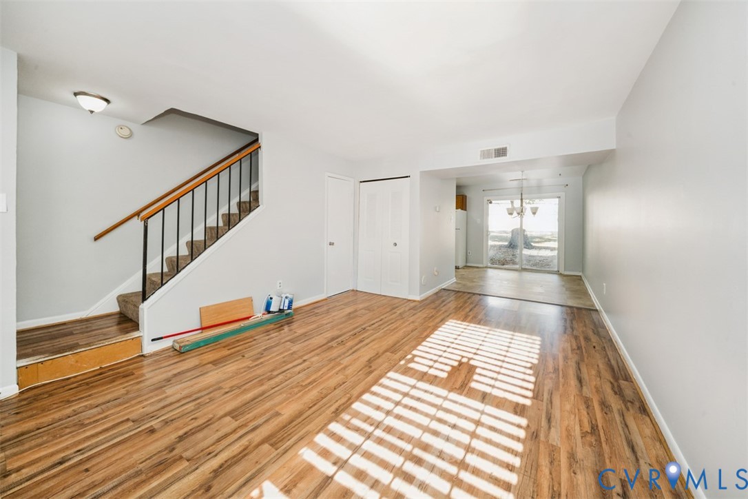 1508 Stowmarket Court Richmond, VA 23225 - Photo 2 of 13 Unfurnished living room featuring stairway, wood f