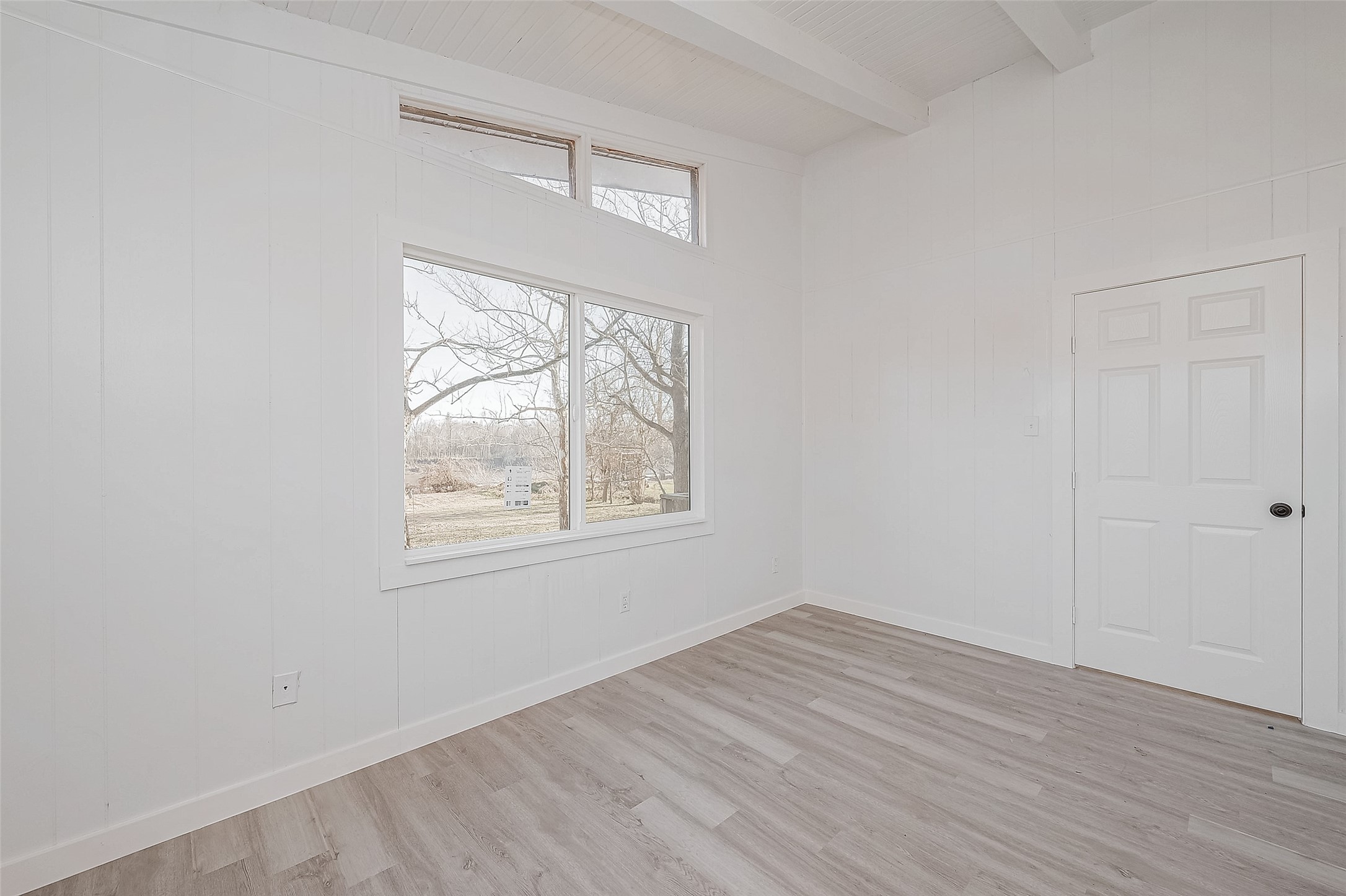 492 Trinity Road Dayton, TX 77535 - Photo 12 of 28 an empty room with wooden floor and windows