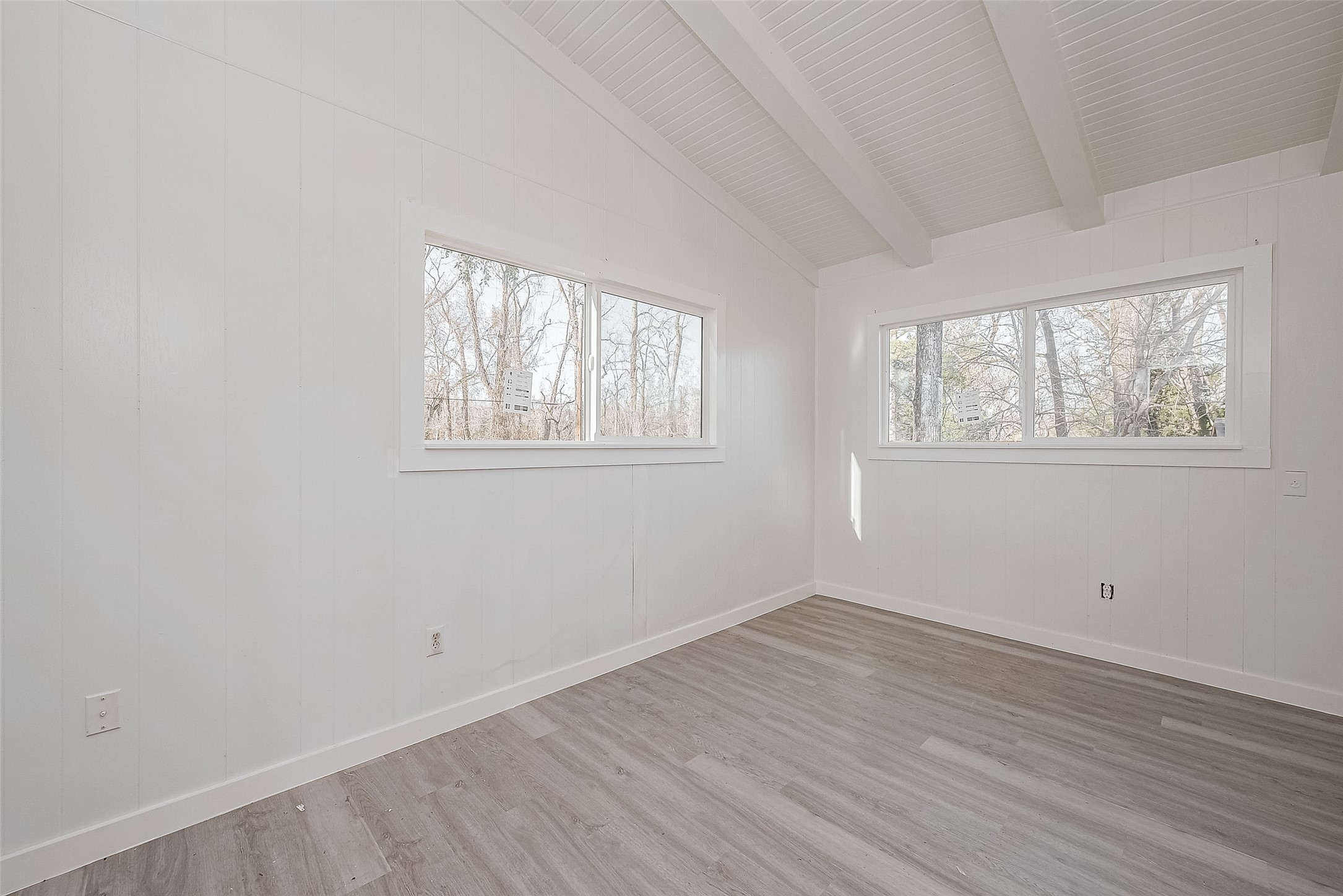 492 Trinity Road Dayton, TX 77535 - Photo 13 of 28 an empty room with wooden floor and windows
