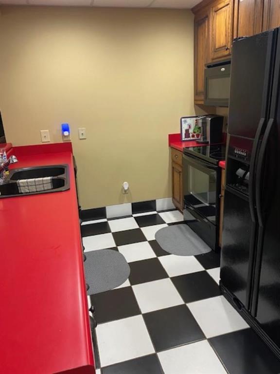 351 Shoals Lane Clarkesville, GA 30523 - Photo 24 of 38 a room with a black white checkered floor kitchen with a sink and a refrigerator