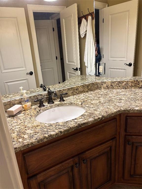 351 Shoals Lane Clarkesville, GA 30523 - Photo 32 of 38 a bathroom with a granite countertop sink and a mirror