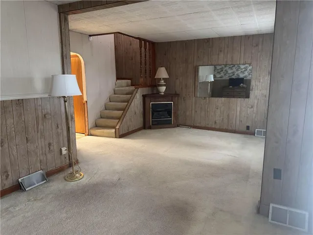 a view of a room with furniture and a window