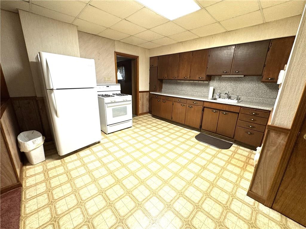 314 Pine Street Ambridge, PA 15003 - Photo 9 of 22 a kitchen with stainless steel appliances a refrigerator sink and cabinets