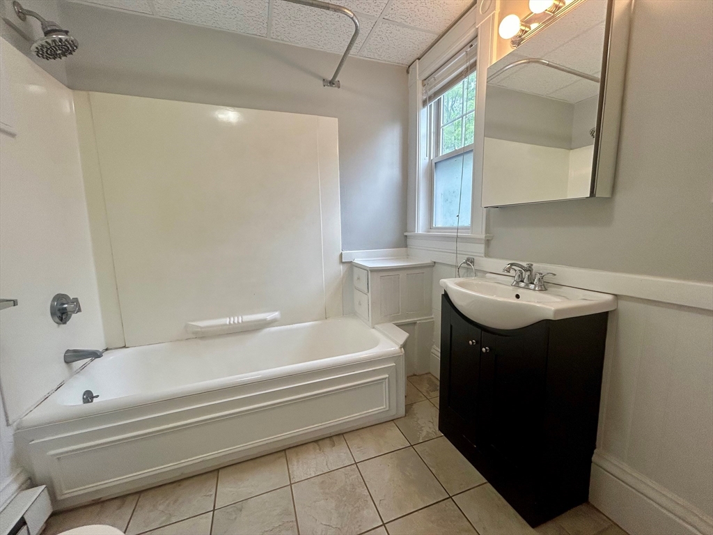 237 Water Street, Unit 2R Clinton, MA 01510 - Photo 8 of 9 a bathroom with a sink a toilet and bathtub