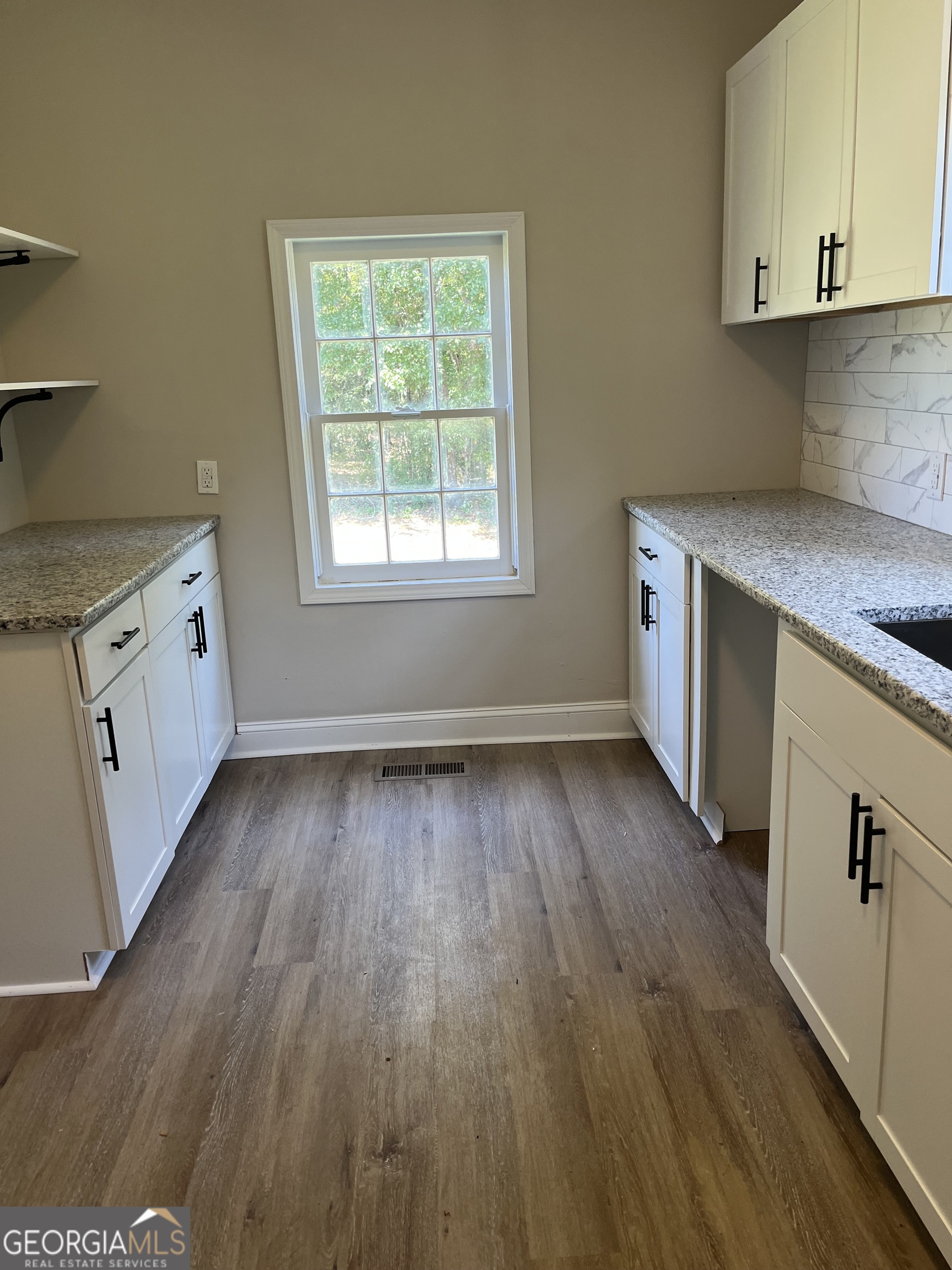 802 J D Parham Drive Manchester, GA 31816 - Photo 11 of 17 an empty room with wooden floor and windows