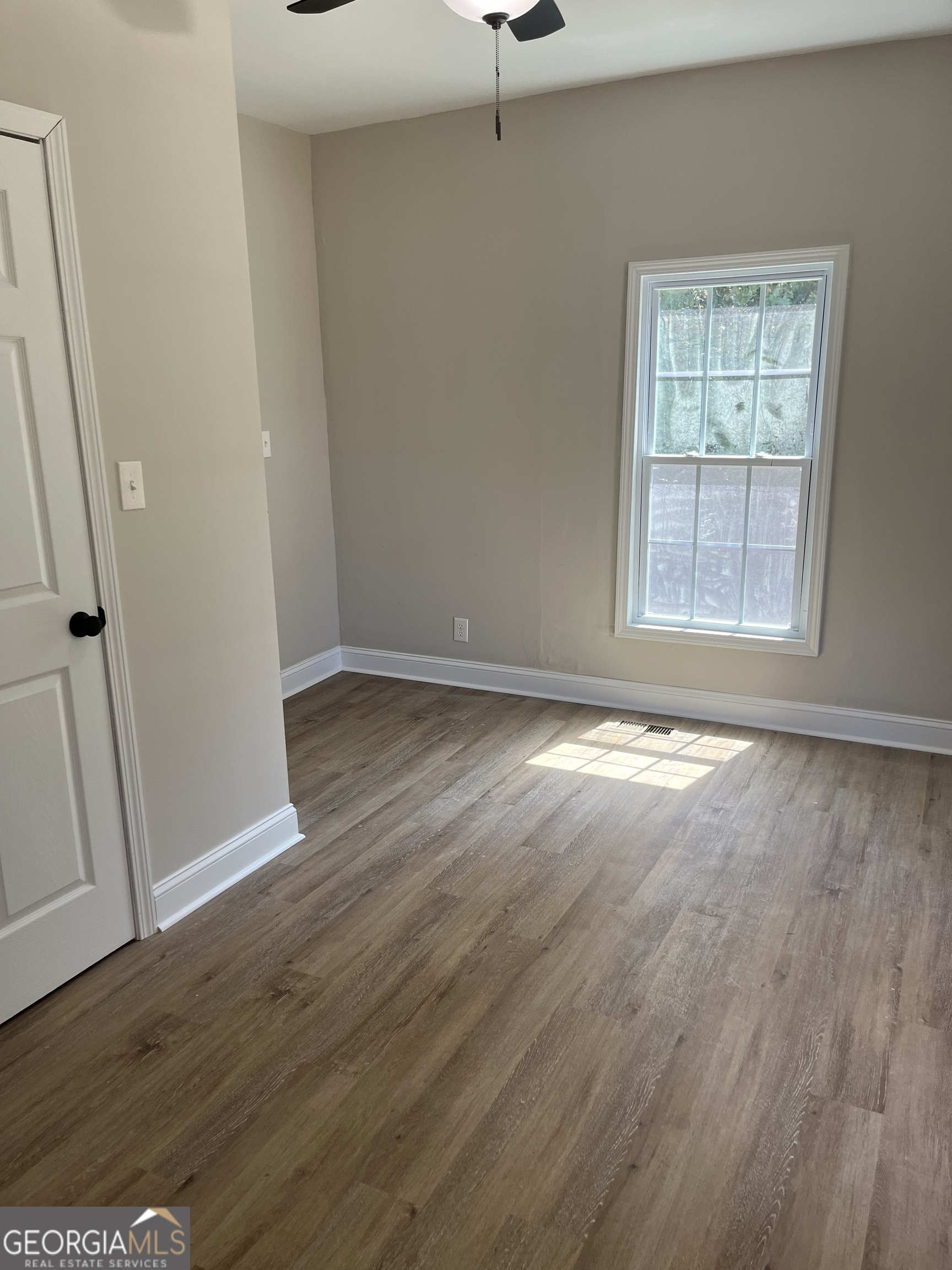 802 J D Parham Drive Manchester, GA 31816 - Photo 17 of 17 an empty room with wooden floor and windows