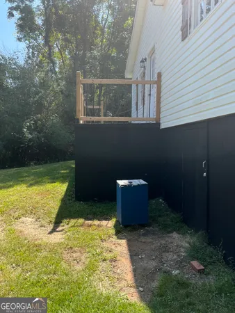 a backyard of a house with dishwasher and wooden fence