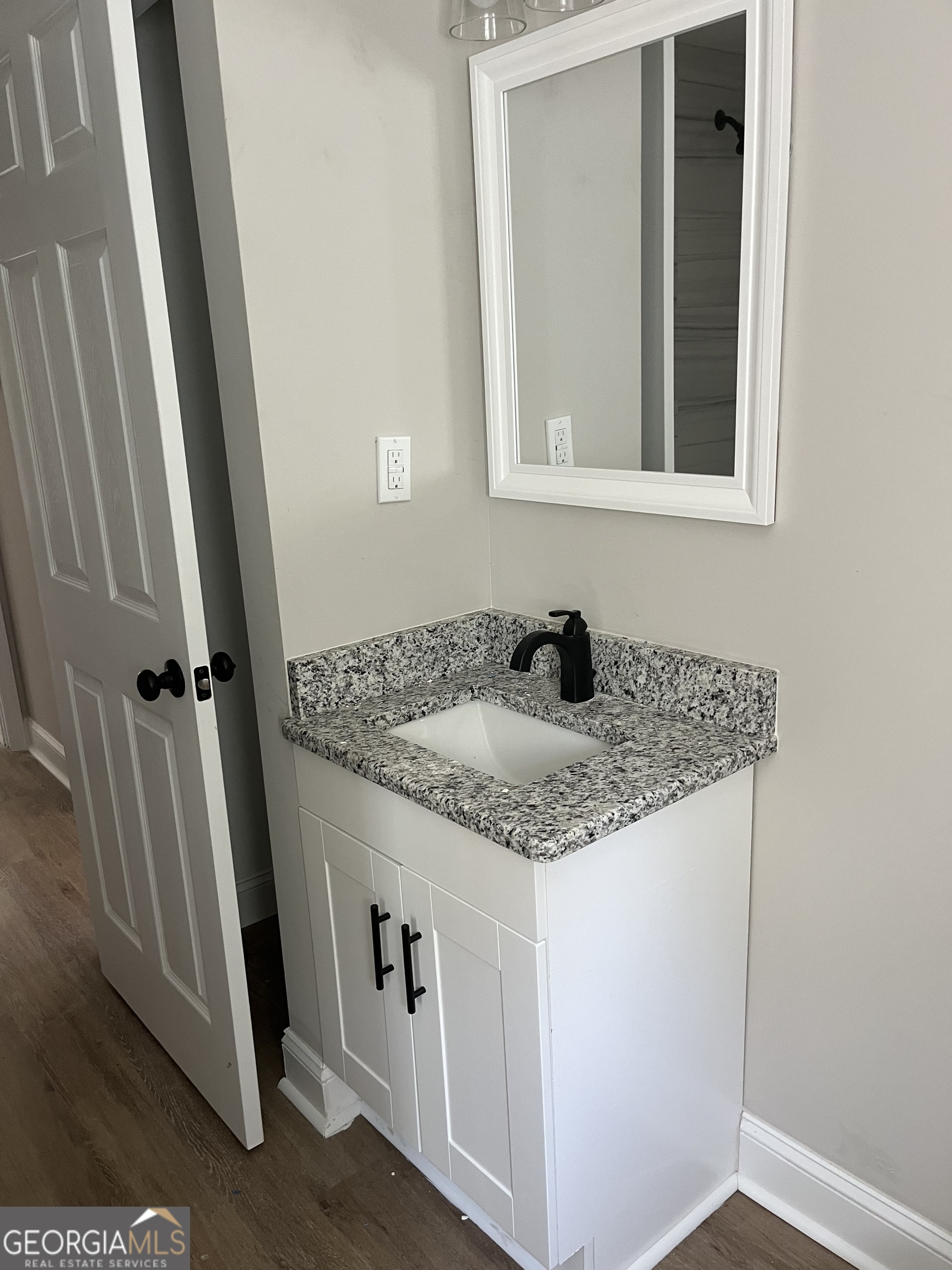 802 J D Parham Drive Manchester, GA 31816 - Photo 6 of 17 a bathroom with a granite countertop sink and vanity