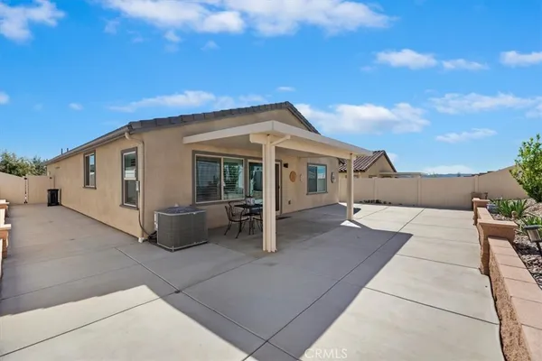 a swimming pool with outdoor seating and yard