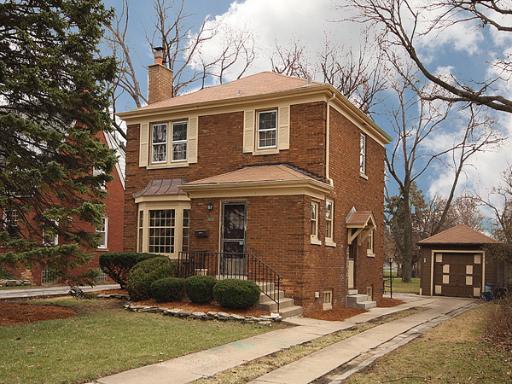 425 Repton Road Riverside, IL 60546 - Photo 1 of 1 a view of a yard in front of a brick house with large windows