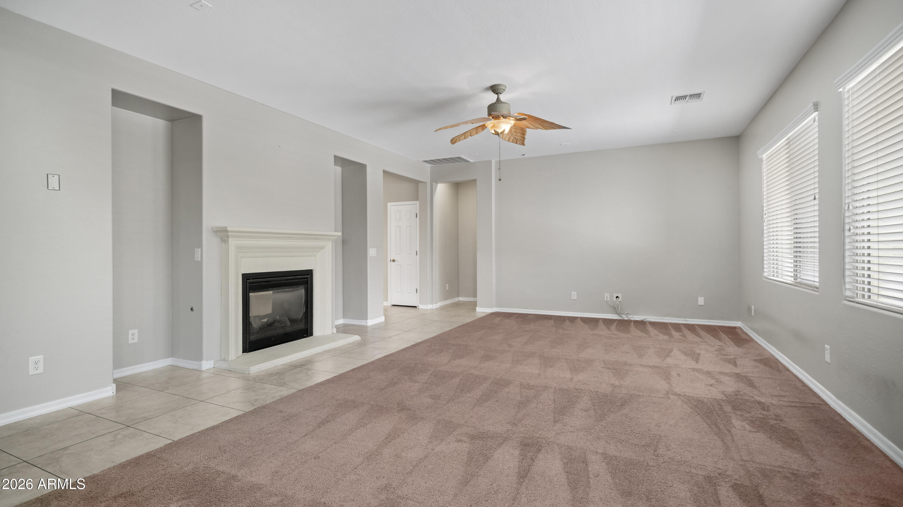 16159 West Granada Road Goodyear, AZ 85395 - Photo 8 of 41 an empty room with windows and fireplace