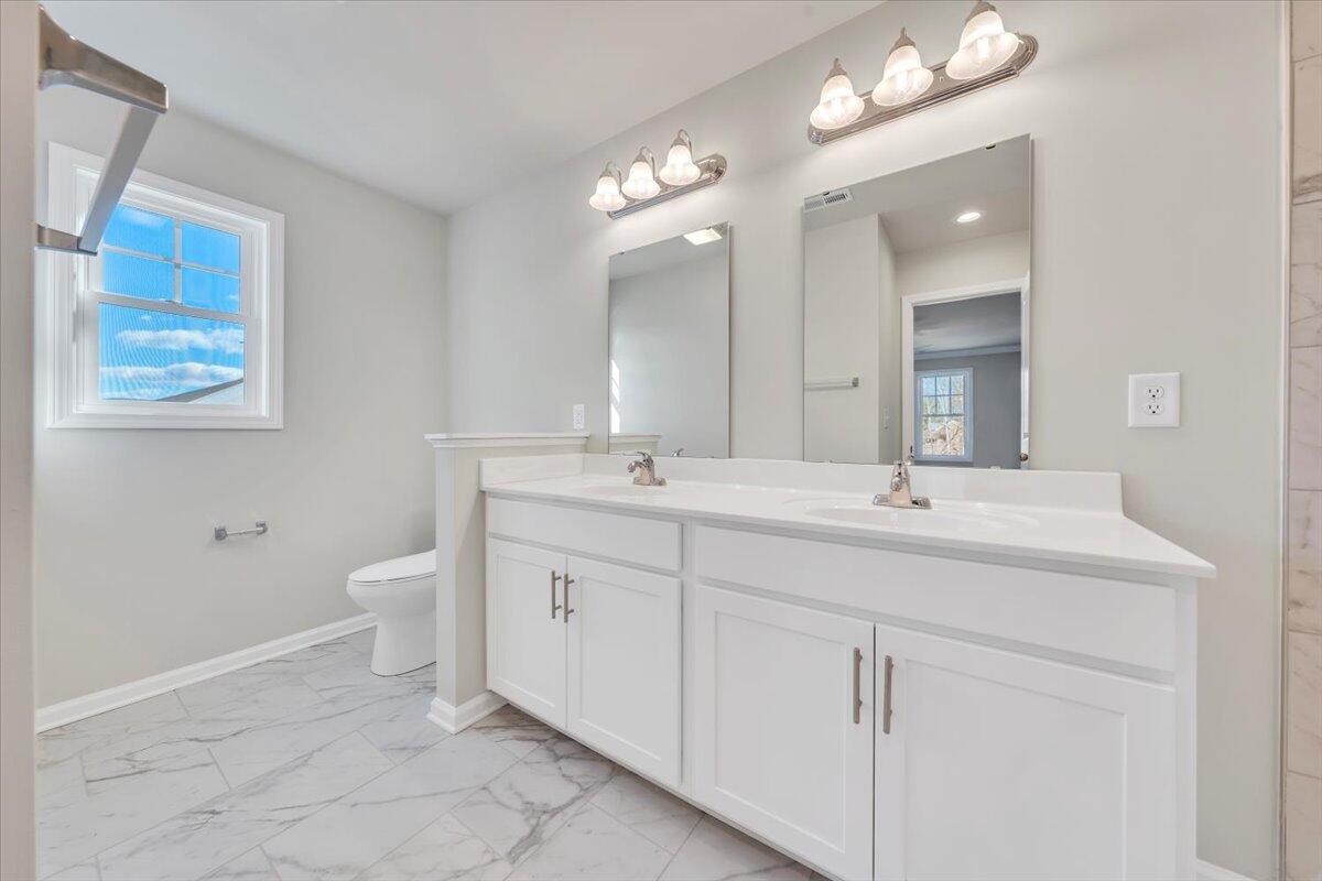 3711 Crescent Ridge Drive Southwest Roanoke, VA 24015 - Photo 12 of 23 a bathroom with a toilet sink and mirror